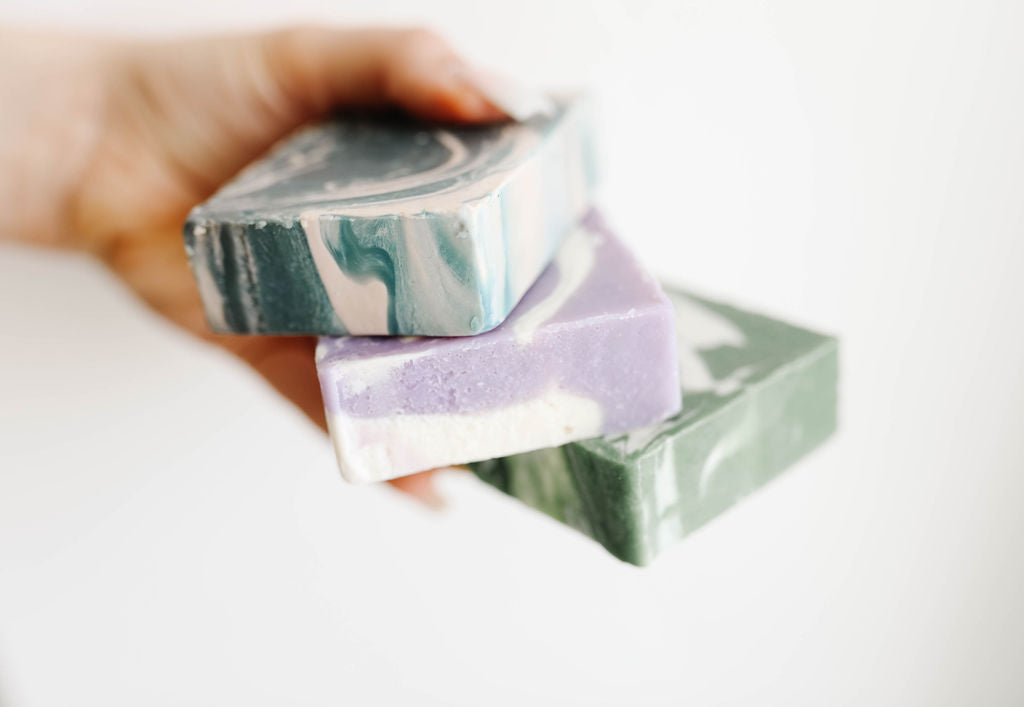 all natural, home made marbled soaps in blue, purple, and green