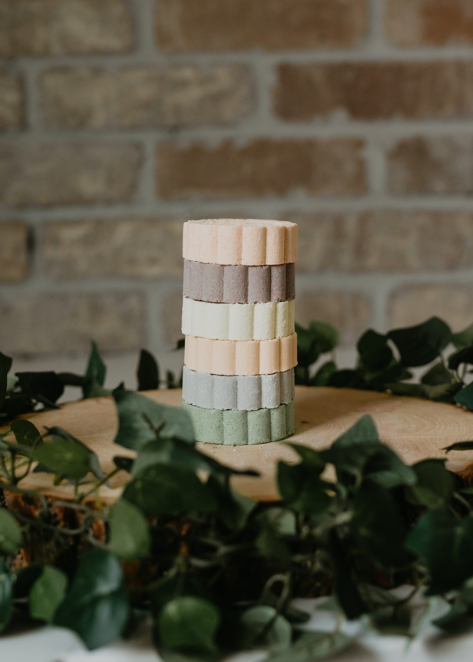 all natural shower steamers stacked on top of a decorative wood slab