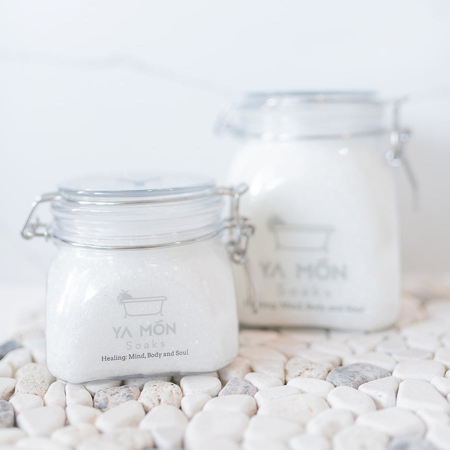 all natural bath crystals or bath salts on a white stone background