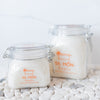 all natural bath crystals or bath salts on a white stone background