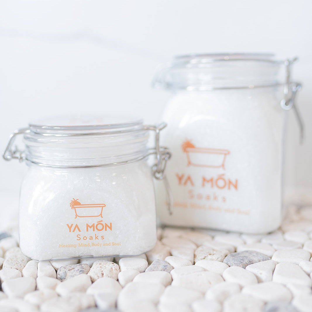 all natural bath crystals or bath salts on a white stone background