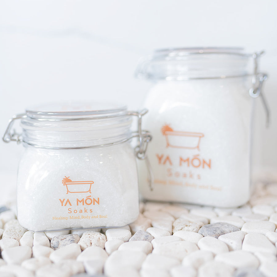 all natural bath crystals or bath salts on a white stone background