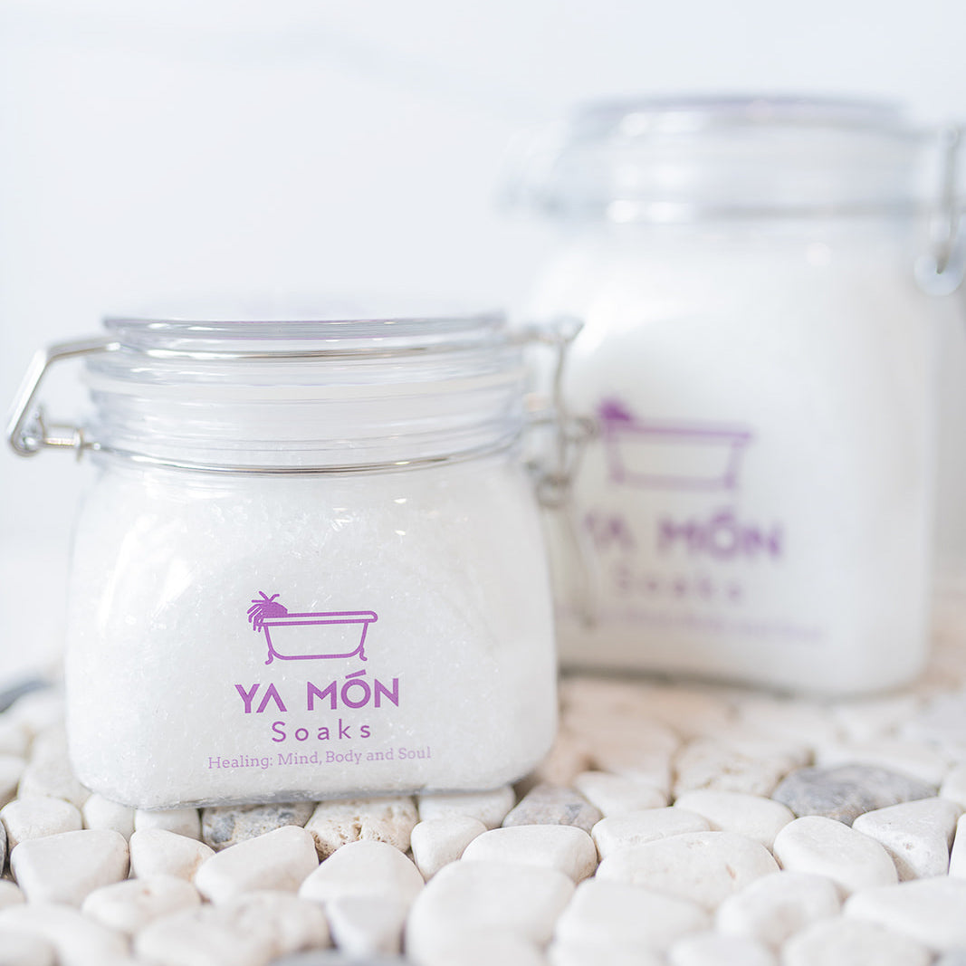 all natural bath crystals or bath salts on a white stone background