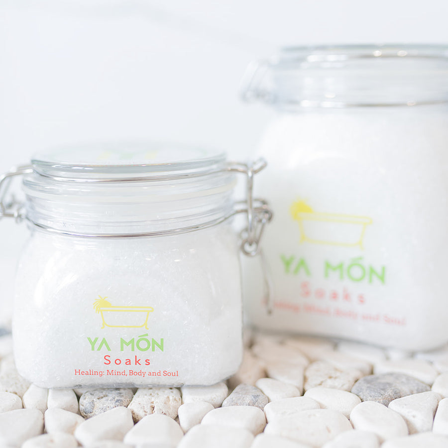 all natural bath crystals or bath salts on a white stone background