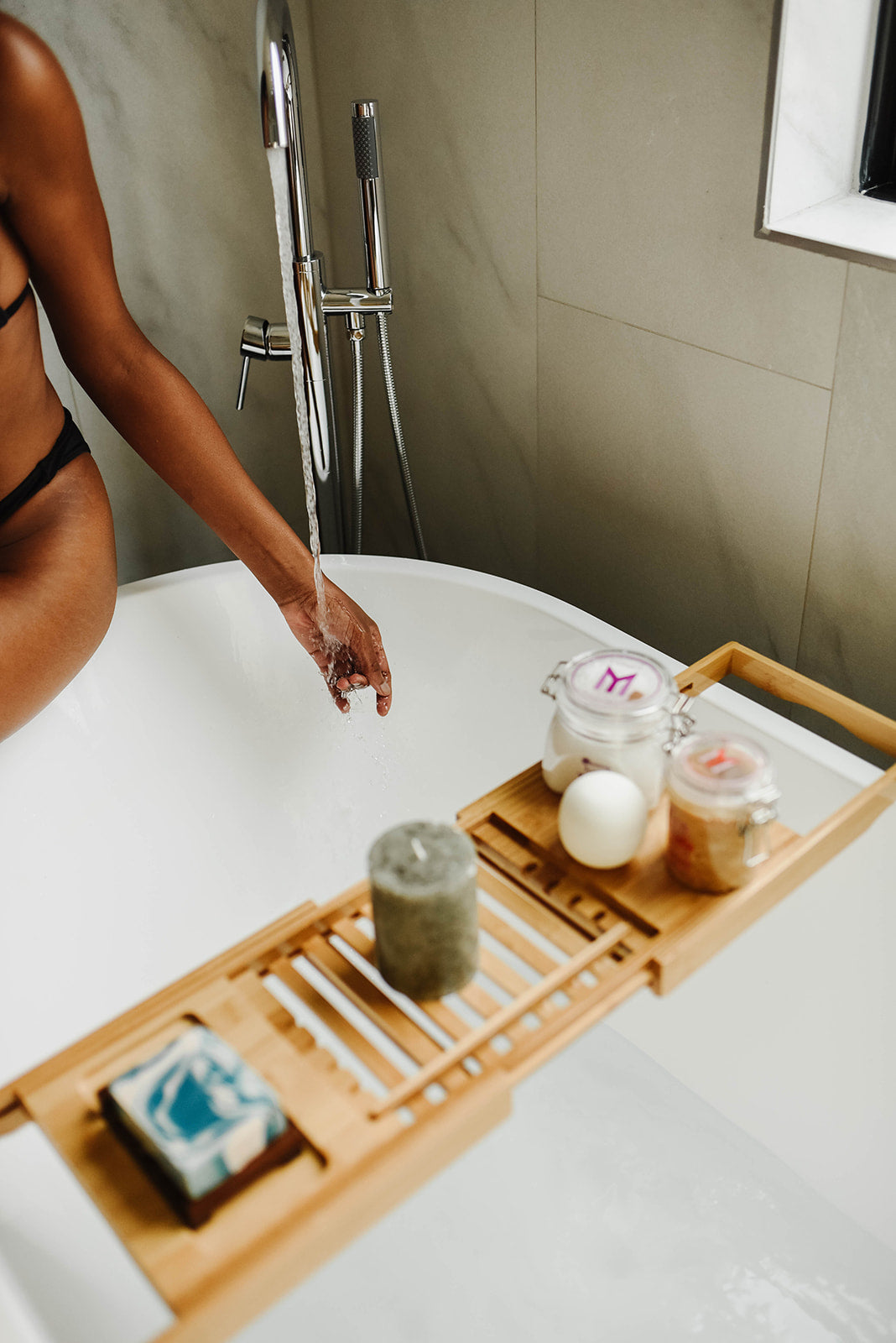 bath caddy filled with all natural soaps, bath bombs, sugar body scrubs, and bath salts or bath crystals